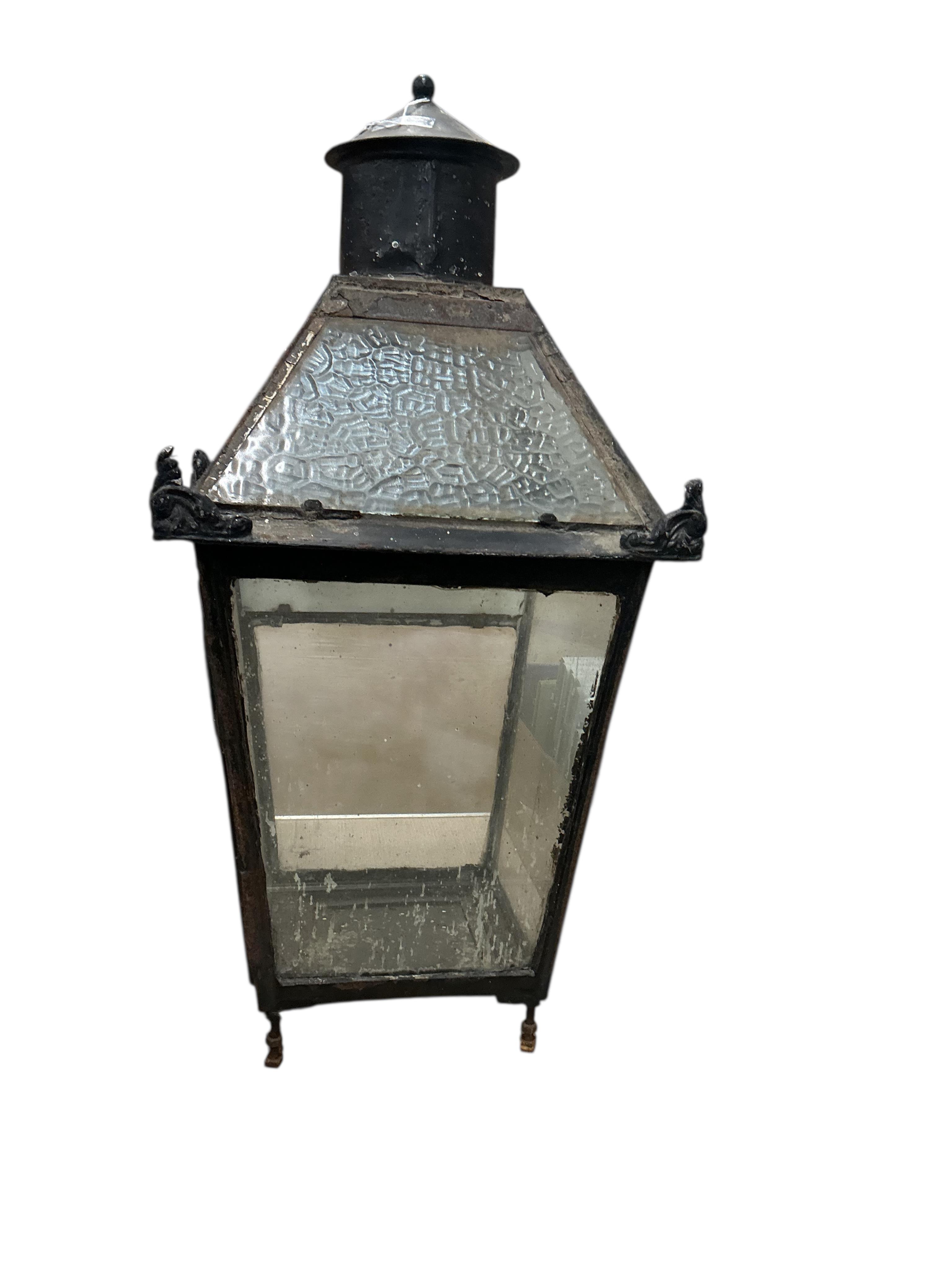 A glass and steel railway station lantern with an opaque glass panel showing the remains of a painted possible station name, missing the burner etc., 80cm high, 40cm wide